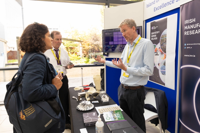 Group of people talking at an exhibition stand